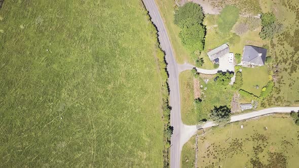 Overhead view of farm land in Devon England. Sky view of fields with stone walls separation and road alt