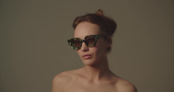 Beautiful Young Woman Adjusting Sunglasses