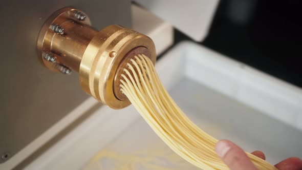 Man Making Fresh Pasta on Traditional Italian Kitchen Machine for Spaghetti Chef Preparing Fresca alt