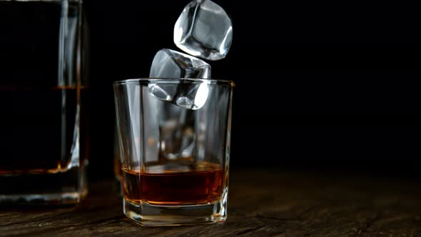 Super Slow Motion Shot of Ice Drop Into Glass with Whiskey at 1000Fps with Camera Movement alt