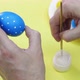 Happy Easter Close Up. White man painting a blue Easter egg in polka dot with white acrylic color - VideoHive Item for Sale