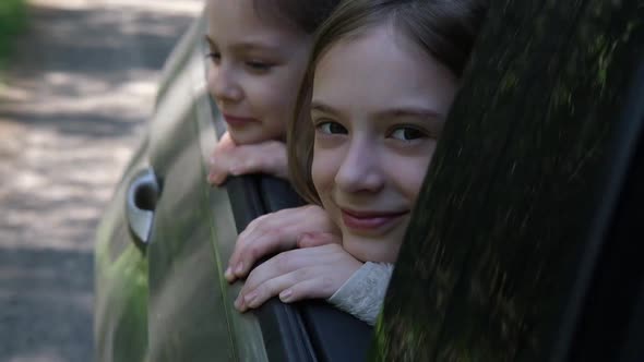 Carefree Children Leaned Out of the Car Window and Smiled