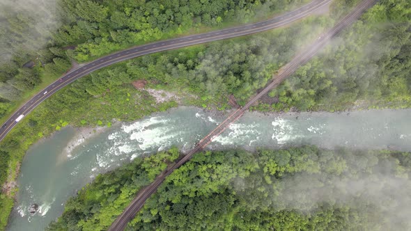 Aerial shot of Nature - Green Trees, River, Road, Bridge, and Railway