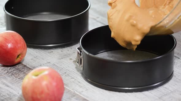 Cake batter pouring into baking dish. Home baking. Making caramel apple cake alt