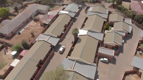 aerial shot following a car driving from an estate alt