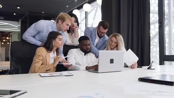 Young Mixed Races Business People Working Under their Joint Computer Project alt