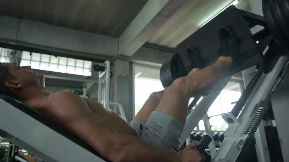 Athletic man exercises in gym fitness for strength training and bodybuilding workout alt