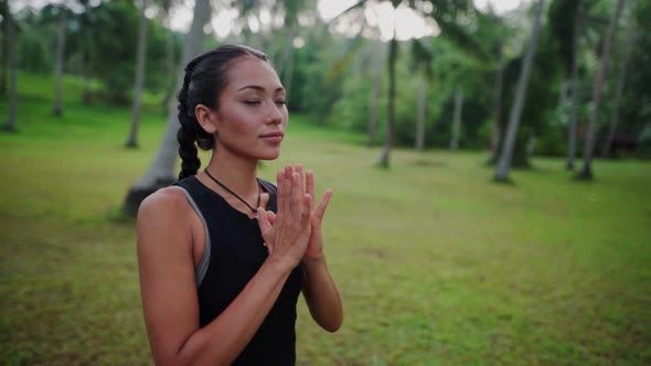 Asian Woman Meditating in the Jungle alt