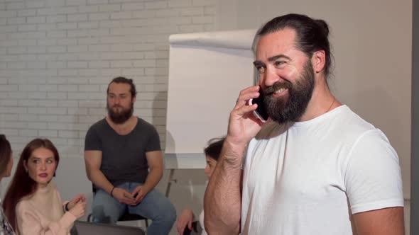 Bearded Mature Businessman Talking in the Phone Joyfully alt