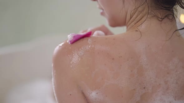 Closeup Shoulder of Slim Young Unrecognizable Caucasian Woman Washing Skin with Flower Petal in Slow alt