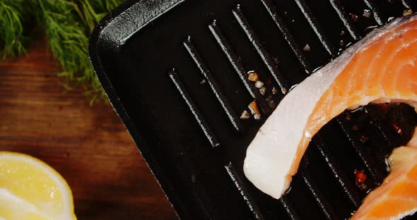 Salmon Steak Is Fried in Oil in a Frying Pan with Spices. 