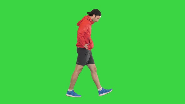 Sportsman Walking and Having a Heart Pain on a Green Screen Chroma Key alt
