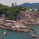 Aerial View of Island Beach with Bungalow and Rocky Coastline at Haad Khom Beach - VideoHive Item for Sale