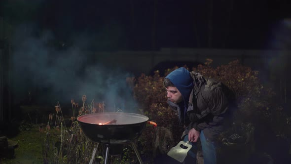 Guy Trying to Break a Stick on His Knee alt