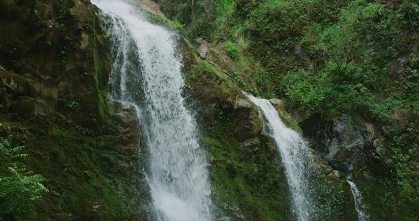 Three epic waterfalls flowing in slow motion in natural jungle setting alt