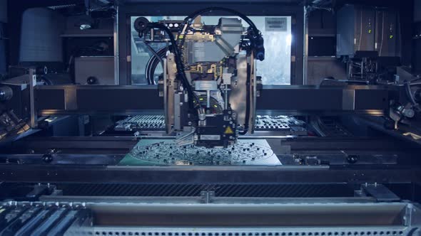 Surface Mount Technology SMT Machine places components on a circuit board alt