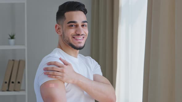 Happy Satisfied Ethnic Guy Arab Man Hispanic Patient Male Posing Indoors Wears White Tshirt Shows alt