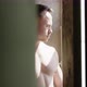 Athlete With Naked Torso Standing By The Window, Looking At The Camera - VideoHive Item for Sale