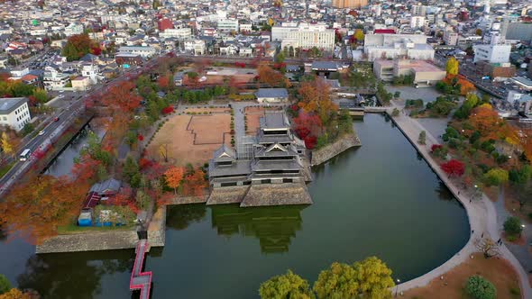 Aerial View 4k footage of Matsumoto Castle on morning in Matsumoto city. alt