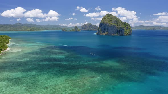 Aerial Drone View of Pinagbuyutan Island with Cloud Shades Moving on Ocean Surface alt