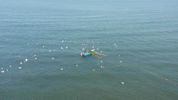AERIAL: Fishermans Catching Fish in the Baltic Sea on a Sunny Bright Spring Day in Klaipeda alt