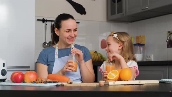 Little Girl with Mother Drinking Fresh Smoothie alt