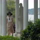 Elegant Woman Walking by Marble Statue in Aivazovsky Park, Crimea - VideoHive Item for Sale