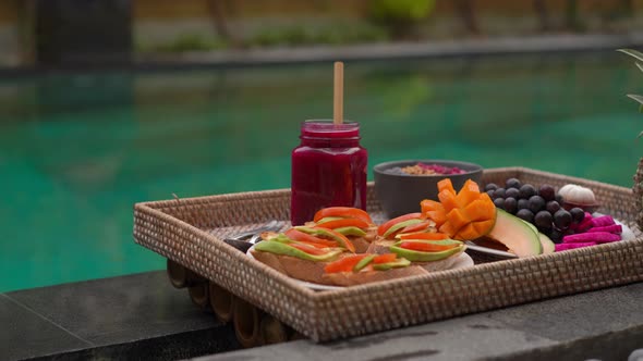 Closeup Shot of a Personal Breakfast on a Floating Table in a Private Swimming Pool alt