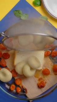 Vertical Tabletop Video Chef Adds Cooked Potato Dumplings to the Baked Tomatoes and Feta Cheese