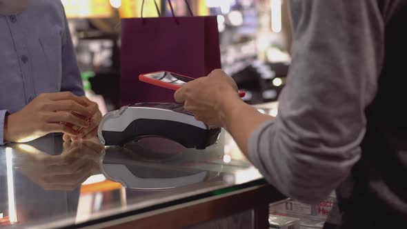 Asian Muslim Man Using Mobile Phone Payment 03 alt