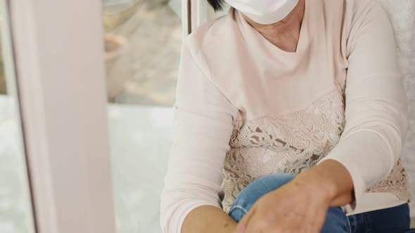 Lonely Asian old woman looking outside the window, Stay home for quarantine. alt