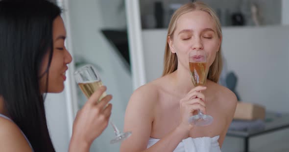 Closeup of Two Delighted Beautiful Multiethnic Women Chilling Together at Henparty in Bathroom alt