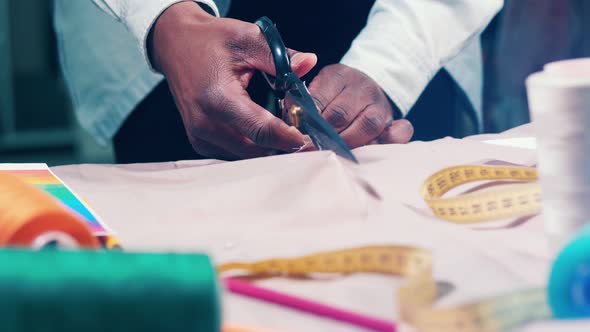 Fabric is Getting Cut Into Halves By a Tailor alt