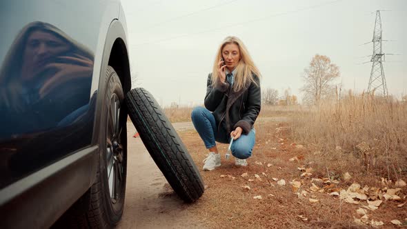 Woman Repairing Accident Car. Sad Disappointed Woman On Broken Car. Car Insurance Service Calling. alt