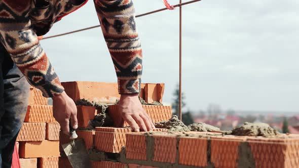 Close Up of a Man Building a Brick House alt