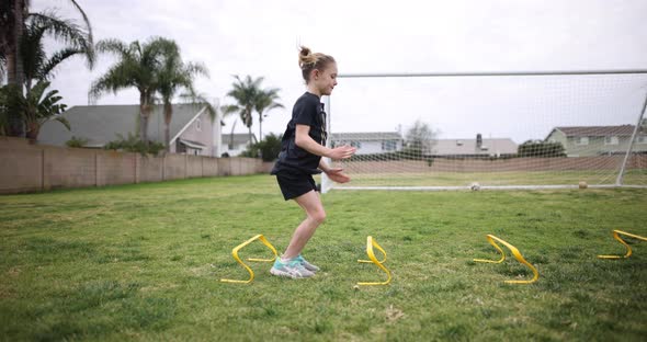 Girl Jumping Over Hurdles