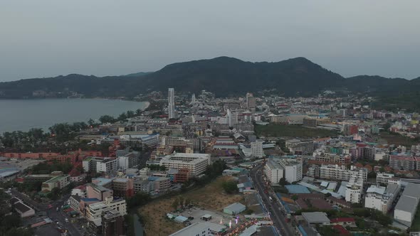 Drone Flight Over the Jungle and Sea City After Sunset alt
