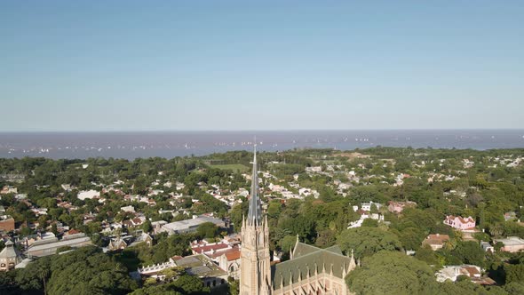 Aerial of San Isidro city revealing the Cathedral with La Plata river behind. Dolly out alt