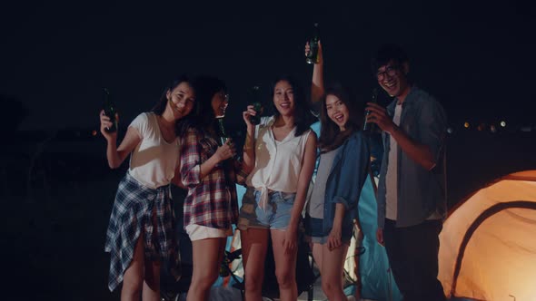 Group of Asia best friends take photo memory dance and drink have fun salute toast of bottle beer.