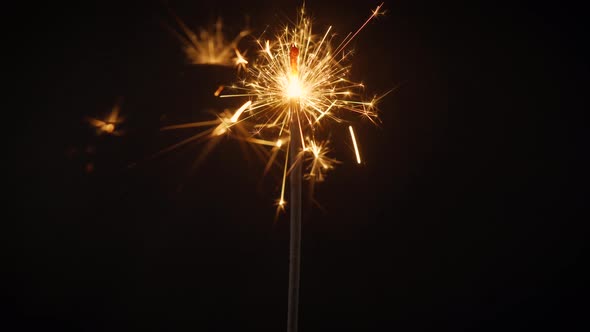 Beautiful Sparks From Cold Stick Fires on a Black Background alt