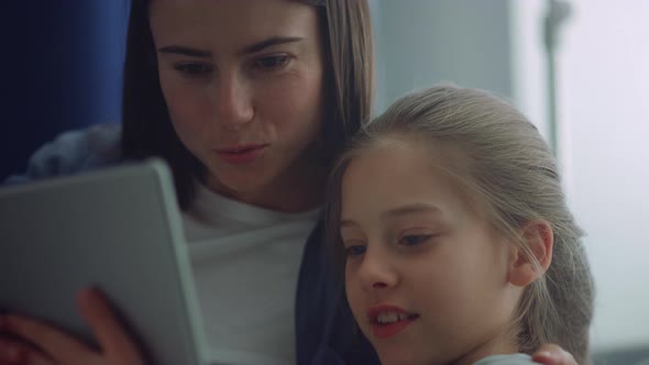 Girl Mother Holding Tablet Computer Play Online Games Together in Room Closeup alt