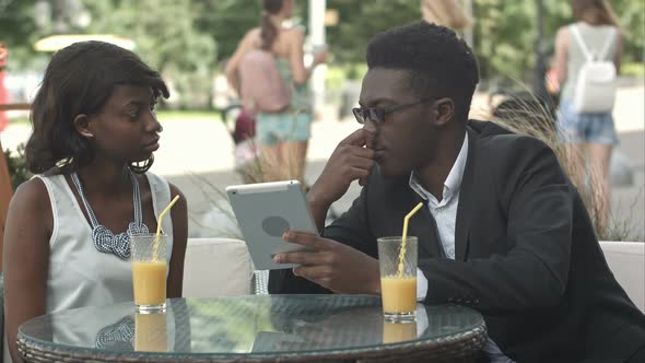 Modern Business People Working with Digital Tablet at a Cafe