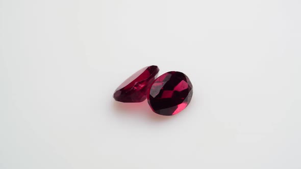 Natural Red Garnet Gemstone on the White Background on the Turning Table alt