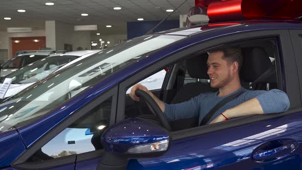 Male Customer Shows His Thumb Up From Inside the Car alt