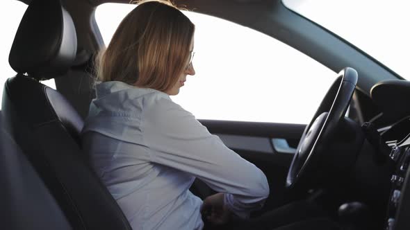 Woman Fastening Seatbelt