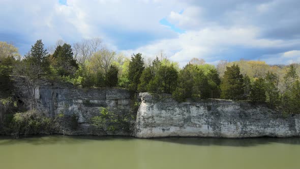 Aerial View of a White Picturesque Cliff Above the Riverside on the Sunset alt