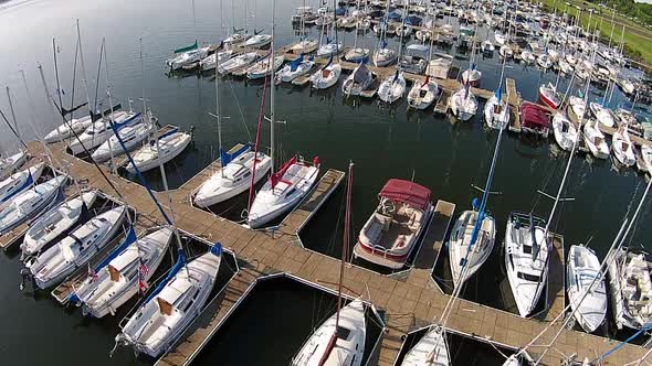 Aerial footage of sailboat marina. alt