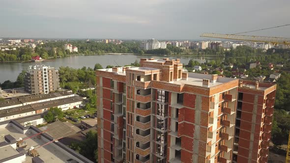 Aerial view of tall residential apartment buildings under construction. Real estate development. alt