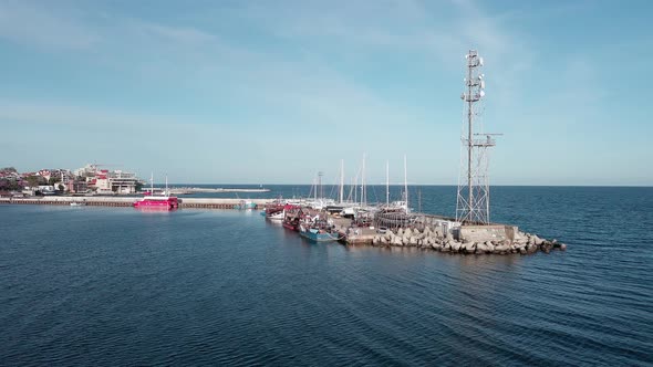 Port with Boats in Black Sea Adjoins the Town of Pomorie in Bulgaria Under a Blue Sky alt