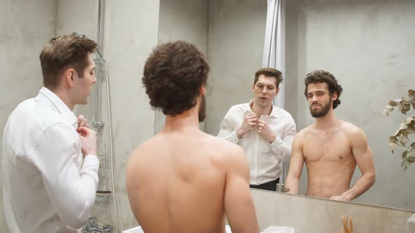 Young Athletic Gay Couple in Front of Mirror in Morning at Bathroom. alt